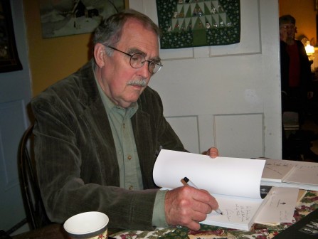 Andrew L. Phelan signing copies of his book Becoming the Village Potter in December 2012.